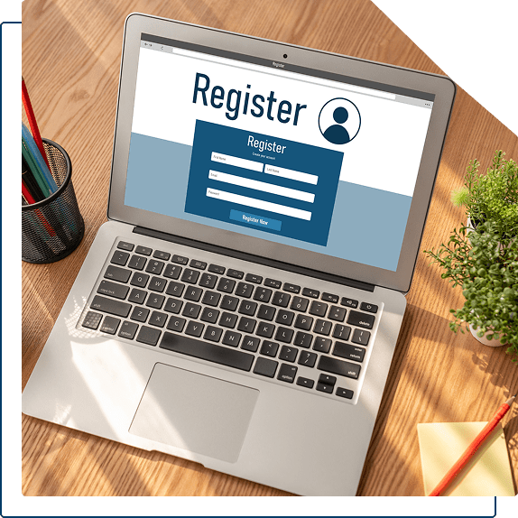 Laptop displaying online registration form webpage.